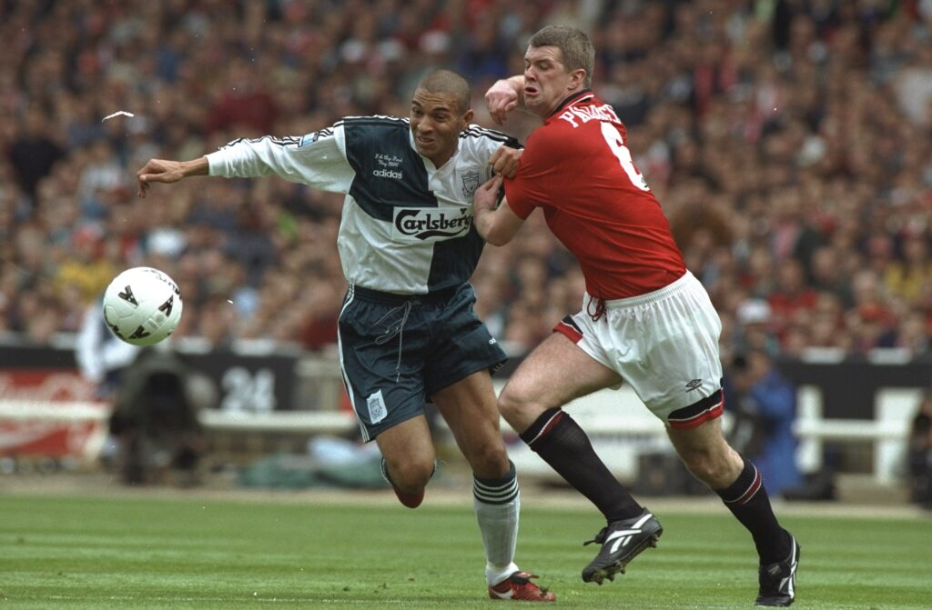 Stan Collymore of Liverpool and Gary Pallister of Manchester United