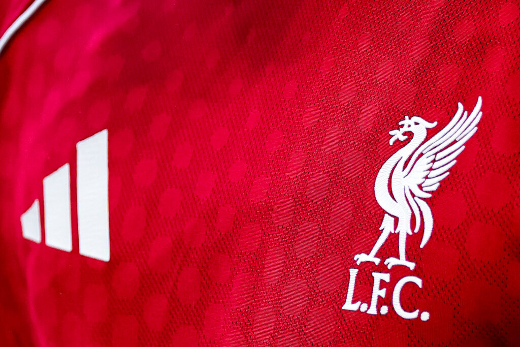 Detail of the Liverpool club crest next to an Adidas logo on the red home shirt during the pre-season friendly match between Liverpool v Athletic Club Bilbao at Anfield on August 4, 2025 in Liverpool, England.