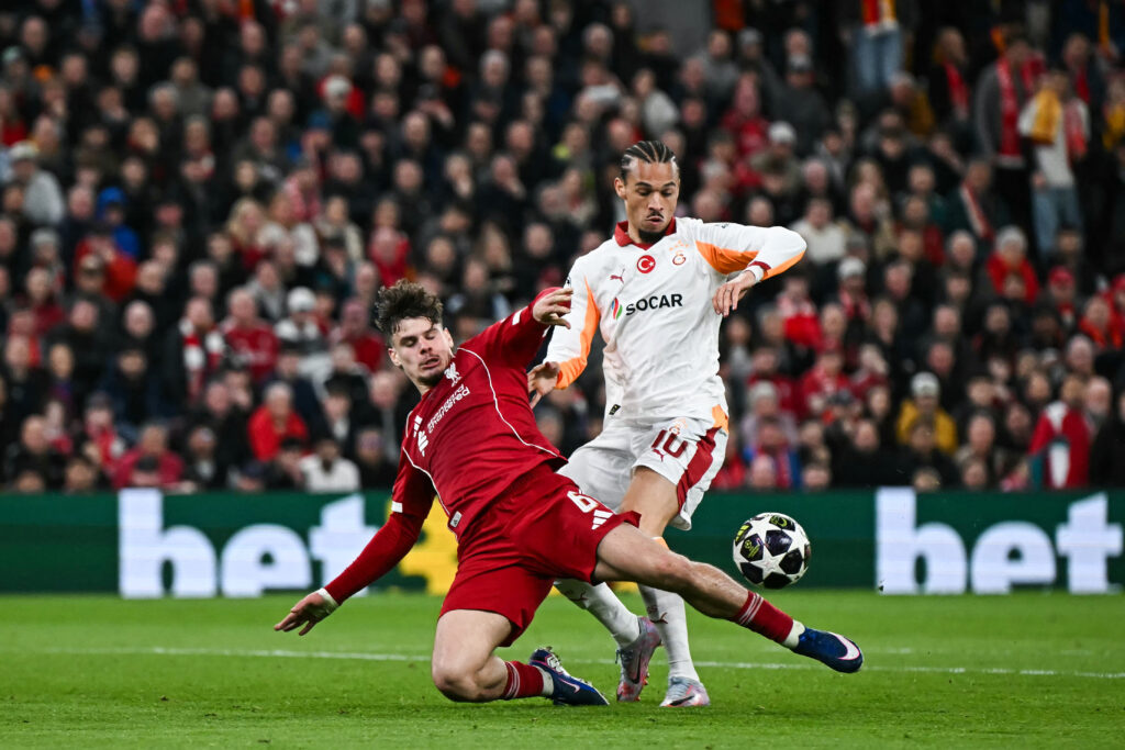 Milos Kerkez and Leroy Sane challenge for the ball during the UEFA Champions League last-16 second-leg between Liverpool and Galatasaray at Anfield