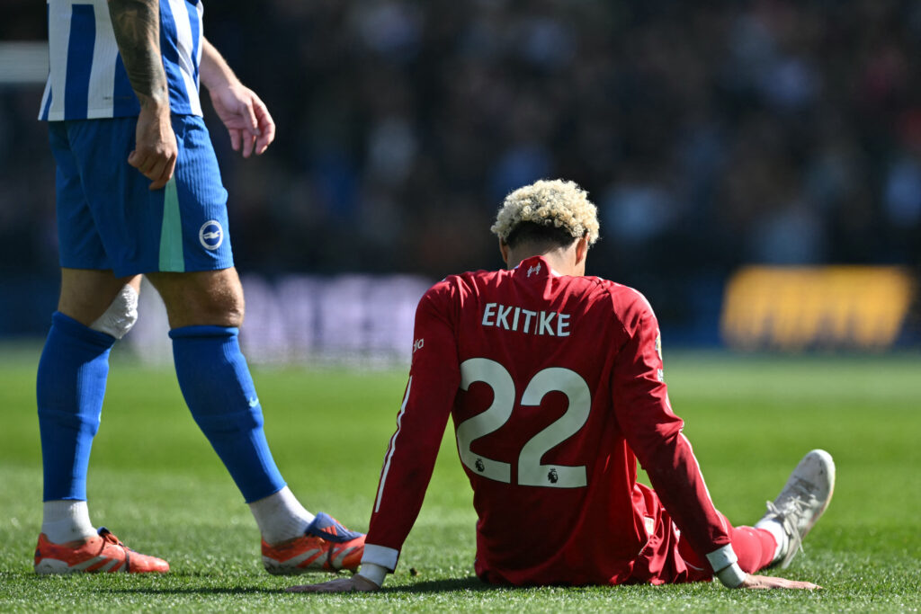 Hugo Ekitike lies injured on the pitch during Liverpool's Premier League match against Brighton & Hove Albion at the Amex Stadium