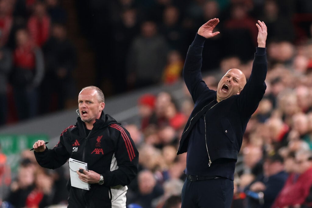 Arne Slot throws his arms in the air during Liverpool's UEFA Champions League last-16 second-leg against Galatasaray at Anfield.