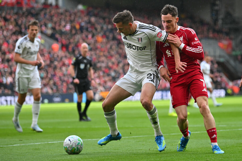 Florian Wirtz battles Timothy Castagne for the ball during Liverpool's Premier League match against Fulham at Craven Cottage