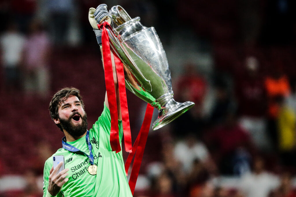 Alisson Becker lifts Champions League trophy