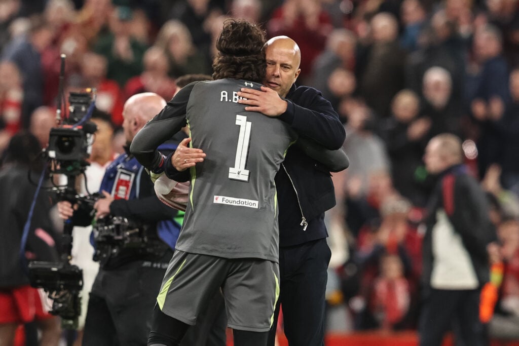 Arne Slot and Alisson Becker embrace after Liverpool's UEFA Champions League round of 16 match against Galatasaray at Anfield.