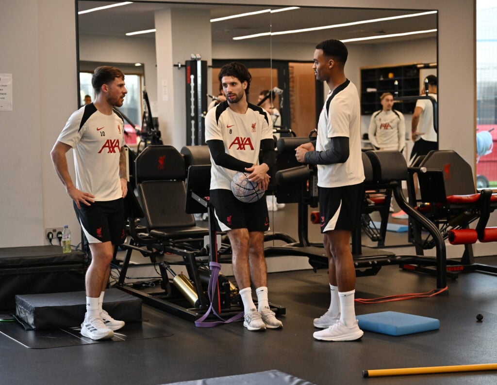 Alexis Mac Allister, Dominik Szoboszlai and Ryan Gravenberch pictured in discussion at Liverpool's AXA Training Centre
